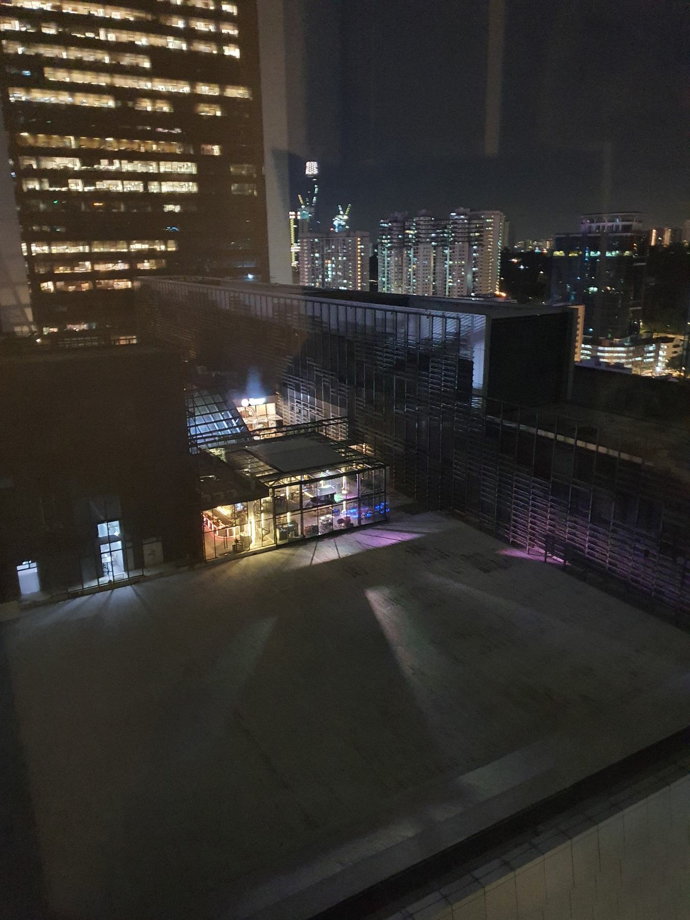 The glasshouse glowing at night from above